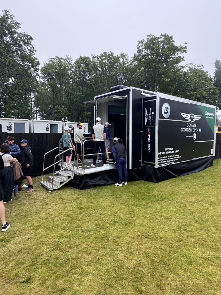 Dryvebox mobile golf simulator trailer with guests on the entrance steps at a UK event
